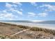 Beautiful view of the beach with boardwalk access on a sunny day at 4305 S Ocean Blvd. # 301, North Myrtle Beach, SC 29582