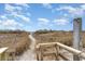 Beach access with a wooden railing and an outdoor shower at 4305 S Ocean Blvd. # 301, North Myrtle Beach, SC 29582