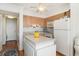 Bright kitchen with wood cabinets, bright decor and a view to the in-unit laundry at 4305 S Ocean Blvd. # 301, North Myrtle Beach, SC 29582
