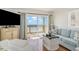 Comfortable living room featuring a balcony overlooking the beach and ocean at 4305 S Ocean Blvd. # 301, North Myrtle Beach, SC 29582