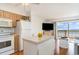 Open living space with a kitchen island, hardwood floors and sliding doors to the balcony overlooking the ocean at 4305 S Ocean Blvd. # 301, North Myrtle Beach, SC 29582