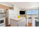 Open living space with a kitchen island, hardwood floors and sliding doors to the balcony overlooking the ocean at 4305 S Ocean Blvd. # 301, North Myrtle Beach, SC 29582