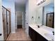Bathroom featuring a double vanity, a tiled shower, and access to a walk-in closet at 4437 Marshwood Dr., Myrtle Beach, SC 29579