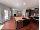 Modern kitchen featuring stainless steel appliances, a large island, and an adjacent living area at 4437 Marshwood Dr., Myrtle Beach, SC 29579