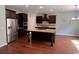 Modern kitchen featuring stainless steel appliances, a spacious island, and dark wood cabinets at 4437 Marshwood Dr., Myrtle Beach, SC 29579