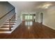 Open-concept living space with hardwood floors and a cozy fireplace, creating a warm ambiance at 4437 Marshwood Dr., Myrtle Beach, SC 29579