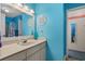 Bright blue bathroom with large mirror, spacious vanity, and decorative accents at 4500 S Ocean Blvd. # 9-B, North Myrtle Beach, SC 29582