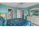 Tranquil bedroom with laundry closet, vibrant turquoise walls, and beach-themed decor at 4500 S Ocean Blvd. # 9-B, North Myrtle Beach, SC 29582