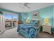 Bright bedroom with a balcony, ceiling fan, and coastal decor exudes a relaxed and airy ambiance at 4500 S Ocean Blvd. # 9-B, North Myrtle Beach, SC 29582