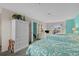 Bright bedroom featuring three beds with floral bedding, wardrobe, and balcony access with ocean view at 4500 S Ocean Blvd. # 9-B, North Myrtle Beach, SC 29582