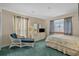 Light-filled bedroom offers a serene retreat with a sitting area and soft, neutral tones at 4500 S Ocean Blvd. # 9-B, North Myrtle Beach, SC 29582