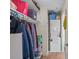 Walk-in closet with neatly organized shelves, hanging clothes, and a stacked washer and dryer at 4500 S Ocean Blvd. # 9-B, North Myrtle Beach, SC 29582