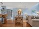 Cozy dining area with modern chandelier, seating for four, and view of the home's living area at 4500 S Ocean Blvd. # 9-B, North Myrtle Beach, SC 29582