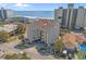 Coastal condo with parking featuring beige siding and a glimpse of the ocean at 4500 S Ocean Blvd. # 9-B, North Myrtle Beach, SC 29582