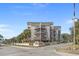 Three-story condo with covered balconies, signage, and well-maintained landscaping at 4500 S Ocean Blvd. # 9-B, North Myrtle Beach, SC 29582
