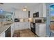 Open kitchen featuring stainless steel appliances and modern countertops, connected to the dining and living areas at 4500 S Ocean Blvd. # 9-B, North Myrtle Beach, SC 29582