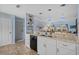 Well-lit kitchen area with granite countertops and modern appliances, leading to other parts of the home at 4500 S Ocean Blvd. # 9-B, North Myrtle Beach, SC 29582