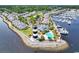 Waterfront community aerial showcasing the lighthouse, pool, marina, and complex of townhomes on the intracoastal waterway at 4652 Lightkeepers Way # 38-C, Little River, SC 29566