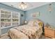 Bedroom with blue walls and window view at 4652 Lightkeepers Way # 38-C, Little River, SC 29566