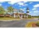 Exterior features home, lighthouse, mature landscaping, and circular driveway with ample parking at 4652 Lightkeepers Way # 38-C, Little River, SC 29566