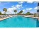 Community pool with ample seating, palm trees, and views of the inter coastal waterway at 4652 Lightkeepers Way # 38-C, Little River, SC 29566