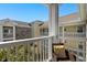 Condo balcony featuring seating overlooking the adjacent residential buildings and vibrant blue sky at 4709 Wild Iris Dr. # 305, Myrtle Beach, SC 29577