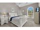 Bright bedroom with a vaulted ceiling, white furniture and a large arched window for natural light at 4709 Wild Iris Dr. # 305, Myrtle Beach, SC 29577