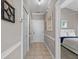 Hallway with tile flooring, neutral paint, and white trim leads to the bedrooms and living spaces at 4709 Wild Iris Dr. # 305, Myrtle Beach, SC 29577