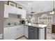 Functional kitchenette with white cabinets, stone countertops and modern dishwasher at 4709 Wild Iris Dr. # 305, Myrtle Beach, SC 29577