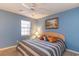 Cozy bedroom with a ceiling fan, window and warm carpet flooring, offering a comfortable retreat at 478 Pinehurst Ln. # 17D, Pawleys Island, SC 29585