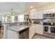 Well-lit kitchen featuring stainless steel appliances, white cabinets, and stone backsplash at 478 Pinehurst Ln. # 17D, Pawleys Island, SC 29585
