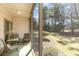 Cozy screened porch with outdoor seating, overlooking a lush green yard and mature trees at 478 Pinehurst Ln. # 17D, Pawleys Island, SC 29585