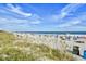 Expansive sandy beach with lounge chairs, umbrellas, and ocean views at 5300 N Ocean Blvd. # 708, Myrtle Beach, SC 29577