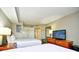 Comfortable bedroom with two beds, dresser with television, and closet at 5300 N Ocean Blvd. # 708, Myrtle Beach, SC 29577