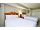 Cozy bedroom featuring two beds, a nightstand, and soft lighting at 5300 N Ocean Blvd. # 708, Myrtle Beach, SC 29577