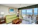 A bright living room with a sofa, chair, and a balcony offering captivating ocean views at 5300 N Ocean Blvd. # 708, Myrtle Beach, SC 29577