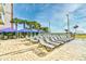 Relaxing poolside with ample lounge chairs and palm trees, creating a tranquil oasis at 5300 N Ocean Blvd. # 708, Myrtle Beach, SC 29577