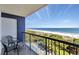 Balcony view of the beach and ocean with green chairs overlooking the serene landscape at 5308 N Ocean Blvd. # 503, Myrtle Beach, SC 29577