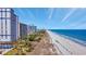 Stunning beach view featuring high-rise buildings, a sandy beach, and endless ocean, offering a perfect coastal lifestyle at 5308 N Ocean Blvd. # 503, Myrtle Beach, SC 29577