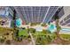 Aerial view of resort pools and manicured grounds with palm trees, offering luxurious amenities and outdoor recreation at 5308 N Ocean Blvd. # 503, Myrtle Beach, SC 29577