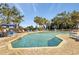 Inviting swimming pool area surrounded by lounge chairs and lush palm trees on a sunny day at 5308 N Ocean Blvd. # 503, Myrtle Beach, SC 29577