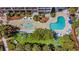 Aerial view of the pool area with lush landscaping, lounge chairs and blue umbrellas, perfect for relaxation and outdoor enjoyment at 5308 N Ocean Blvd. # 503, Myrtle Beach, SC 29577