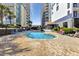 Outdoor pool area surrounded by lounge chairs and lush landscaping between buildings at 5308 N Ocean Blvd. # 503, Myrtle Beach, SC 29577