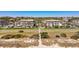 Aerial view of beachfront condos with lush landscaping, palm trees, and a convenient pedestrian crosswalk to the beach at 5601 N Ocean Blvd. # C-311, Myrtle Beach, SC 29577