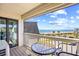 Relax on this balcony overlooking a scenic beach with blue skies and a charming table setting at 5601 N Ocean Blvd. # C-311, Myrtle Beach, SC 29577