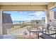 Enjoy stunning ocean views from this condo balcony, complete with seating and views of a palm-lined beach at 5601 N Ocean Blvd. # C-311, Myrtle Beach, SC 29577