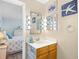 Bathroom vanity with beach decor, twin mirrors with lights, and wood paneled lower cabinet at 5601 N Ocean Blvd. # C-311, Myrtle Beach, SC 29577