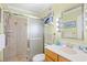 Bright bathroom featuring a glass-enclosed shower, vanity with a sink, and beach-themed decor at 5601 N Ocean Blvd. # C-311, Myrtle Beach, SC 29577