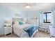 Charming bedroom with coastal decor, a comfy bed, and a glimpse of the ocean outside the window at 5601 N Ocean Blvd. # C-311, Myrtle Beach, SC 29577