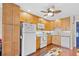 Bright kitchen features wood cabinets, white appliances, and nautical decor at 5601 N Ocean Blvd. # C-311, Myrtle Beach, SC 29577